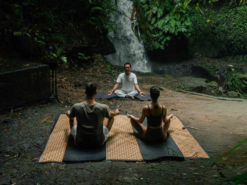 Equipoise Resort Ubud yoga classes take place in an open-air yoga shala overlooking the surrounding greenery. 