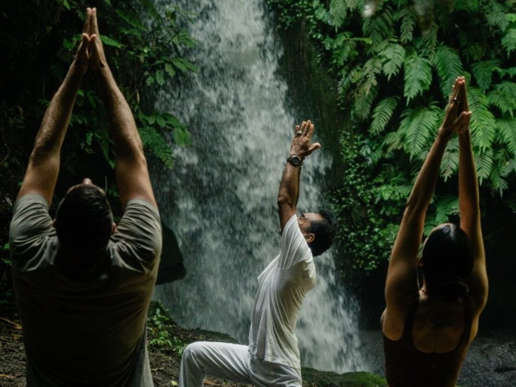 yoga near a waterfall in Bali offers a different experience compared to an indoor yoga studio
